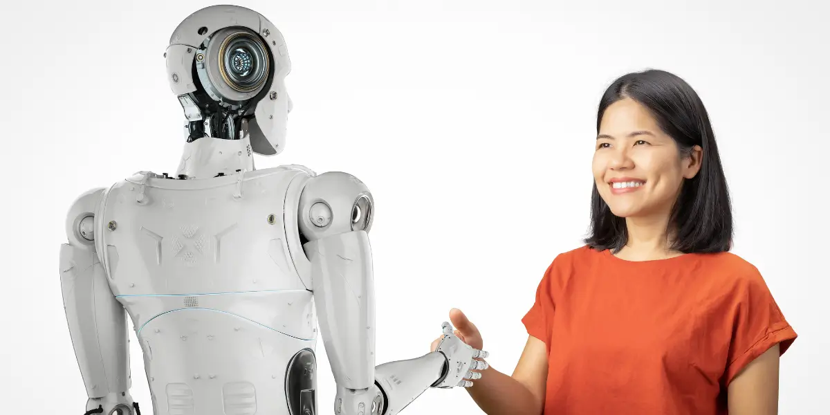 Mulher cumprimentando robô humanoide, simbolizando a interação entre humanos e inteligência artificial.